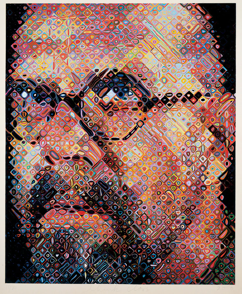A Chuck Close self-portrait: his face built from a diagonal grid of small hand-painted cells, each an abstract shape on its own, resolving into a portrait from a distance.