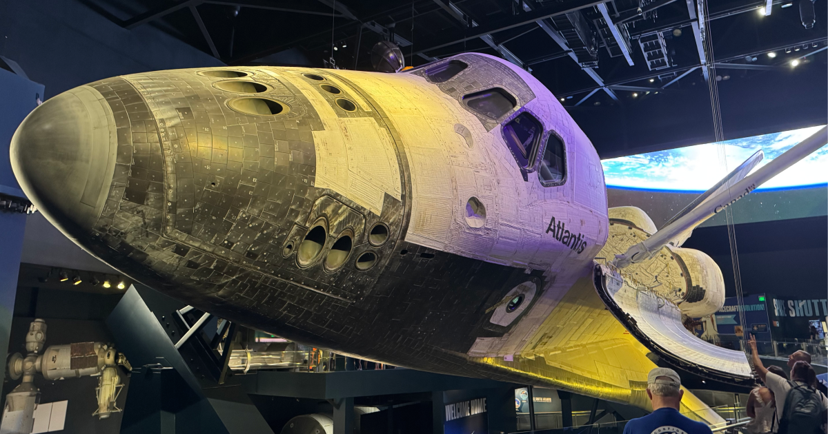 The space shuttle Atlantis suspended at eye level, close enough to touch.
